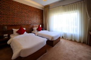 מיטה או מיטות בחדר ב-Hotel Dolmaling