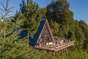 Cabaña Alpina Experience : مجموعة من الناس تقف على سطح منزل صغير