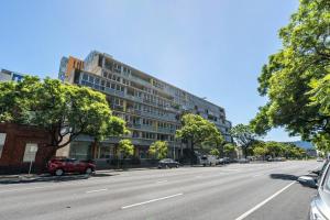 an empty city street with a large building at Wattle on Morphett - Central CBD WiFi in Adelaide