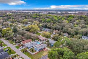 an aerial view of a town with a house and trees at SMV Elegant Beach Home Near Mayo in Jacksonville Beach