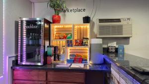 a kitchen with a counter top with a refrigerator at City Center Motel in Medford