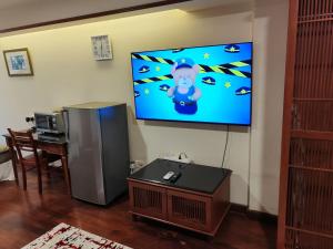 a living room with a flat screen tv on a wall at Port Dickson Teluk Kemang Pantai Tanjung Gemok by 3SIBS in Port Dickson