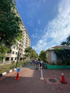 a street with orange cones on a brick road at Port Dickson Teluk Kemang Pantai Tanjung Gemok by 3SIBS in Port Dickson +5 photos