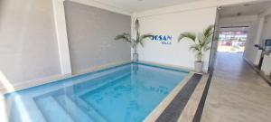 a large swimming pool in a room with a pool at Josan Villa with a Glorious Beach and Sea View in Habaraduwa Central