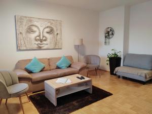 a living room with a couch and a table at Große Ferienwohnung Burgenland in Eisenstadt