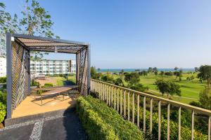a bench on a porch with a fence at Autumn Condo in Hua Hin