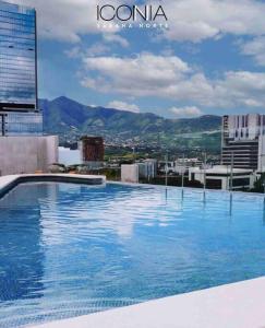 a large swimming pool on top of a building at Pura Vida Hub - Iconnia in San José +35 photos