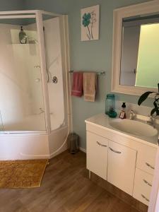 a bathroom with a tub and a sink and a shower at Cozy corner in Thames