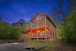 a large wooden house at night with a starry sky at Best Views in Ellijay - Waffle Bar-King Bed-HotTub in Ellijay