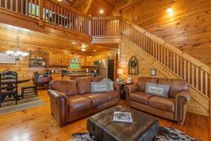 a living room with leather furniture in a cabin at Best Views in Ellijay - Waffle Bar-King Bed-HotTub in Ellijay