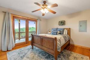 a bedroom with a bed and a ceiling fan at Best Views in Ellijay - Waffle Bar-King Bed-HotTub in Ellijay