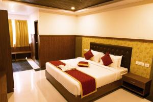 a bedroom with a large bed in a room at HOTEL GRAND ORCHID in Tirupati