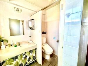 a bathroom with a toilet and a sink and a shower at Hotel Happy Holiday Ishigakijima - Vacation STAY 04124v in Ishigaki Island +22 photos