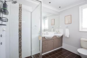 a bathroom with a shower and a sink and a toilet at Bluewater Jervis Bay - Pet Friendly with Spa in Callala Beach