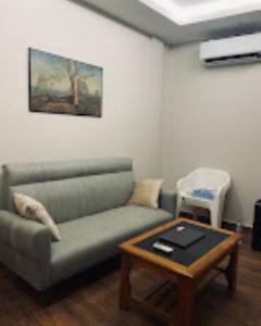 a living room with a couch and a coffee table at Sunset Homes Imphal in Imphal