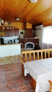 a kitchen with a table and a fireplace in a room at Villa Detelina Balchik in Balchik