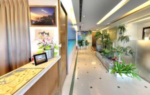 a lobby with potted plants in a building at Blue Ocean Hotel in Keelung