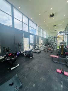 a gym with a bunch of treadmills and machines at Reizz Residence By D'Amour in Kuala Lumpur