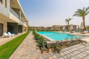 a swimming pool in the backyard of a house at El Gouna Luxury flat on the pool in El Gouna