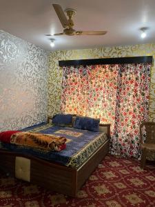 a bedroom with a bed with a dog laying on it at Hotel Kashmir Heaven in Srinagar