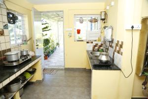 a kitchen with a sink and a counter top at Lourdu Peter Hill Nest in Kotagiri