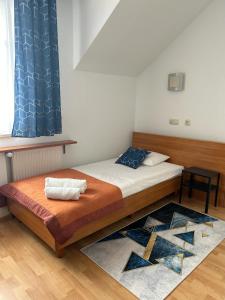 a bedroom with a bed with a blue curtain at Hotel Sutoris in Bochnia