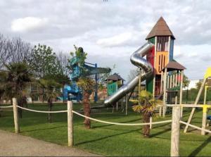 a playground with a slide in a park at 3-Bed homely modern caravan in Clacton-on-Sea in Clacton-on-Sea
