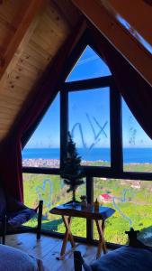 ein Zimmer mit einem großen Fenster mit einem Tisch davor in der Unterkunft İnziva Bungalow1 in Ardeşen