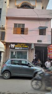 a car parked in front of a dental clinic at Goroomgo Comfort Hostel Charbagh Lucknow Near Railway Station in Lucknow