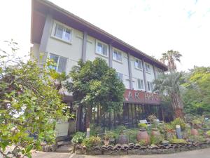 a building with a lot of plants in front of it at Star House in Jeju