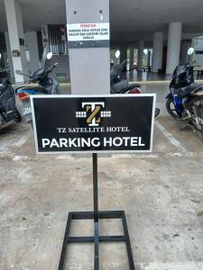 a sign for a parking hotel in a parking lot at TZ SATELLITE HOTEL, Kota Bharu in Kota Bharu