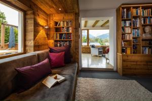 a living room with a couch and bookshelves at Beautiful cosy House near Königsee in Schönau am Königssee