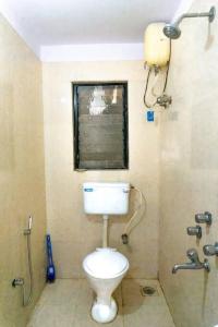 a bathroom with a toilet and a shower at THE PERFECT STAYS: MOUNTAIN MANOR VILLA in Lonavala