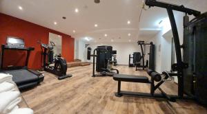 a gym with several tread machines in a room at Hotel Rheinischer Hof in Garmisch-Partenkirchen