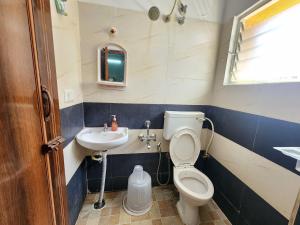 a small bathroom with a toilet and a sink at SQUARSTAY in Bangalore