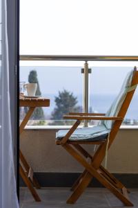 una silla de madera sentada frente a una ventana en Level 5 - sea view & free parking, en Saints Constantine and Helena