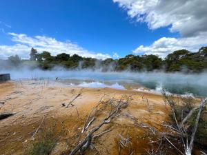 a body of water with steam coming out of it at Parkview Holiday Home "Opposite of Famous Kuirau Park" in Rotorua