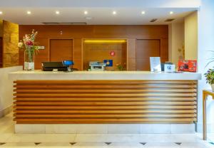 a lobby of a hotel with a reception counter at Sterling in Madrid