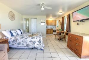 a bedroom with a bed and a living room at Daytona Shores Inn and Suites in Daytona Beach