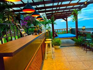 a bar on a patio with a view of the ocean at Sing Sing Resort Lovina in Lovina