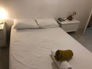 a white bed with a towel on it in a bedroom at Le cocon boulevard Yves farge in Lyon