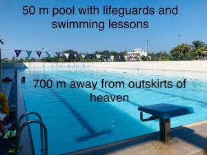 a swimming pool with a bench next to the water at Outskirts Of Heaven in Kamburugamuwa