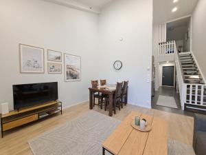 a living room with a television and a dining room at Starvillas B302 in Kalajoki