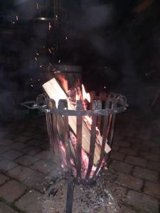 a grill with a fire in it on a street at Musik und Natur - Balboo - Bayrischer Wald - Sauna - Pool - Grillen in Spiegelau