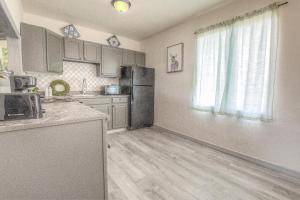 a kitchen with a refrigerator and a counter top at Daytona Shores Inn and Suites in Daytona Beach