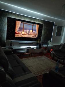 a living room with a large flat screen tv at Dylan Executive 1 Bedroom Apartment in Nakuru