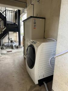 a washing machine is sitting in a room at North River701 Peace Wing 7 新サッカースタジアム近辺 in Kami-nagarekawachō