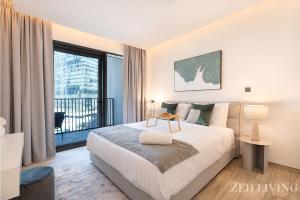 a bedroom with a large bed and a large window at Zed Living - Ahad Residences - Tranquil 1 BR in Business Bay in Dubai