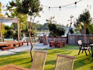 a backyard with a picnic table and chairs at Goto - House - Vacation STAY 66191v in Goto