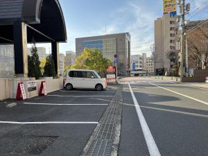 a white car parked in a parking lot at APA Hotel Tottori Ekimae Minami in Tottori